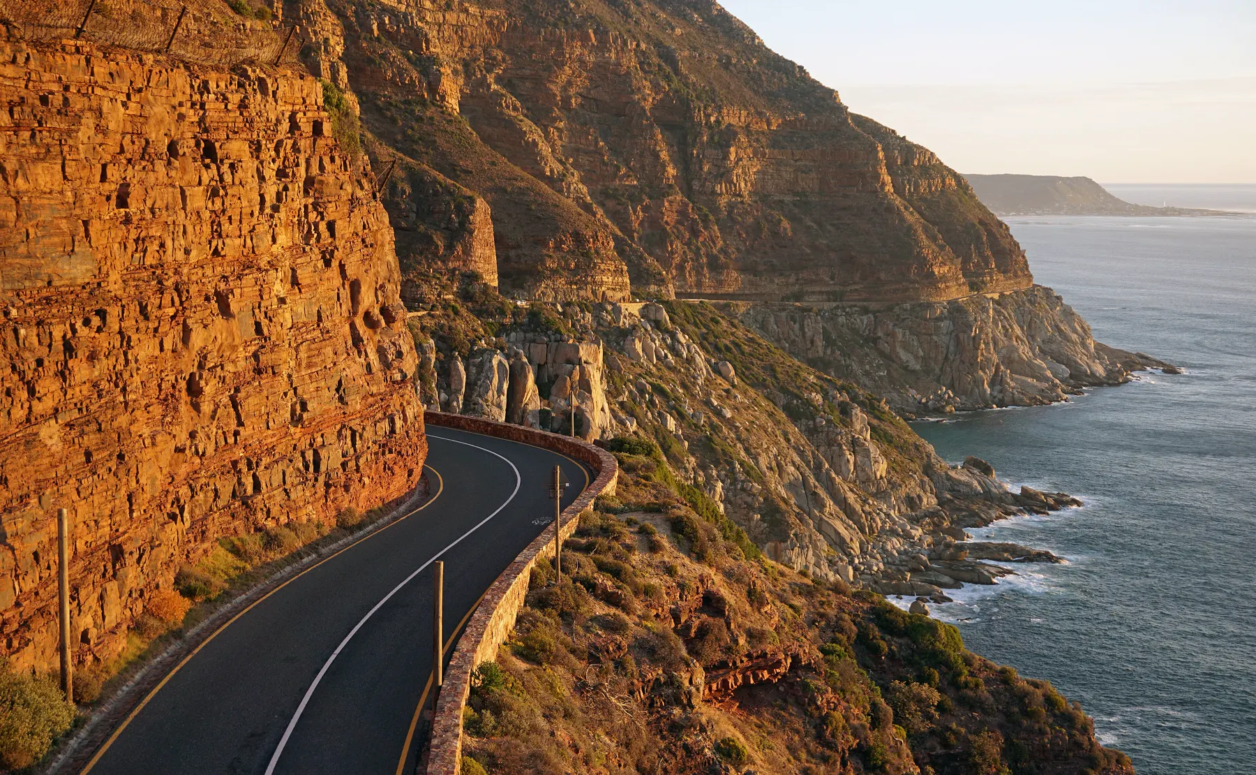 Chapman's Peak Drive cut into orange cliffs above the sea