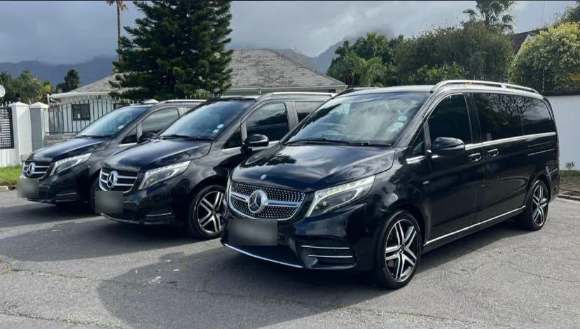 Three black Mercedes-Benz V-Class vans parked in a row
